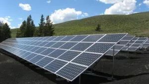 solar panels in front of hill
