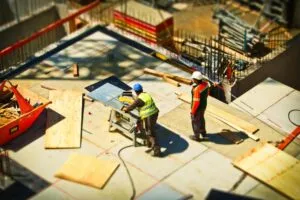 construction workers cutting wood